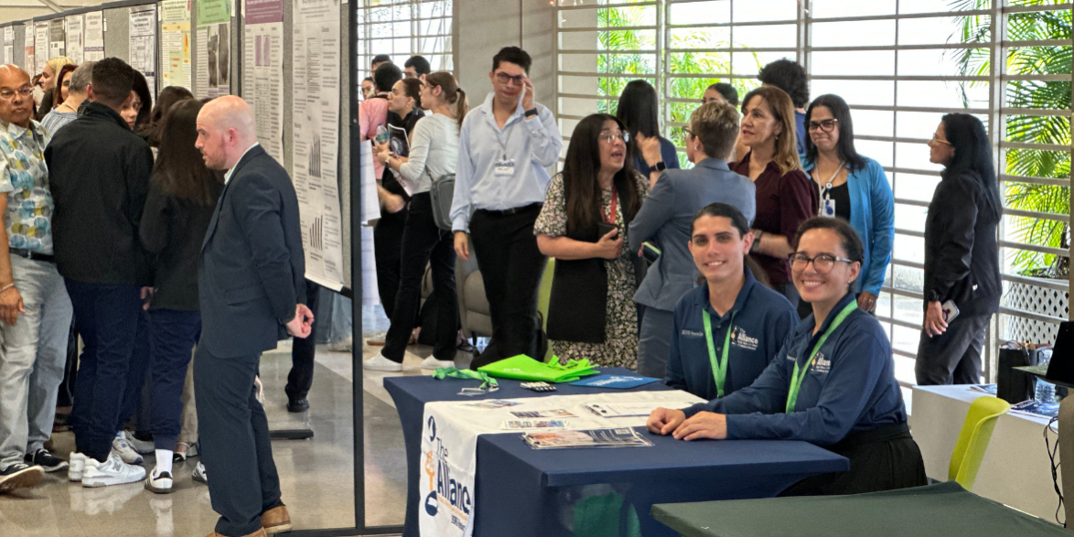 ISCORE Team2 People at an event and on the right is Omar Otero and Catherine Rivera