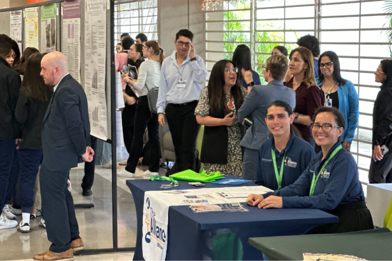 ISCORE Team2 People at an event and on the right is Omar Otero and Catherine Rivera