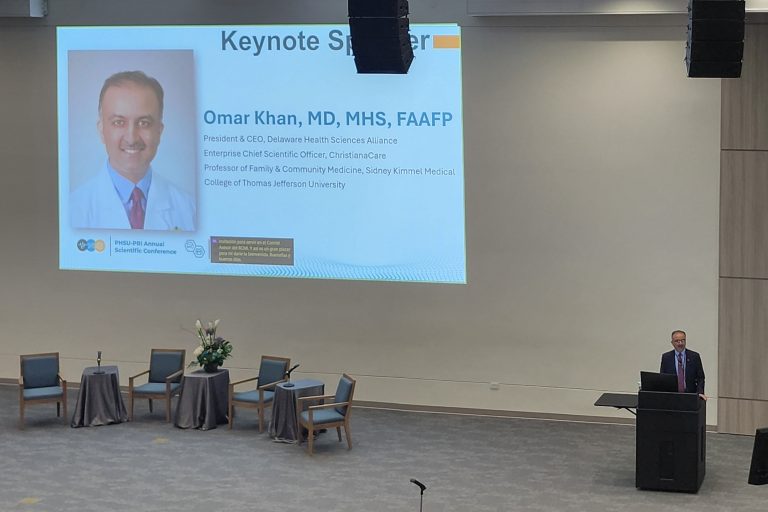 Dr. Omar Khan Dr. Omar Khan as main speaker in an auditorium